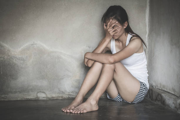 istock Sad woman sitting alone in a empty room . 1155811193