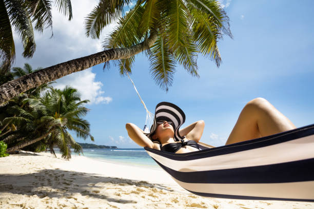 istock Young Woman Relaxing On Hammock Over The Beach 1155812005