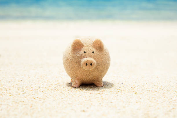 istock Piggybank Made With Sand On Beach 1155812054