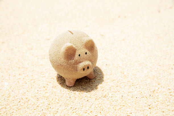 istock Piggybank Made With Sand On Beach 1155812056