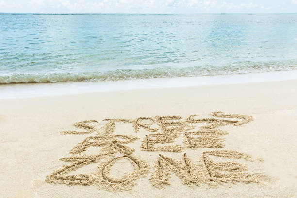 istock Stress Free Zone Written On Sand At Beach 1155812059