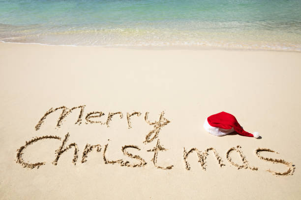 istock Merry Christmas Written Text On Sand Near At Beach 1155812078