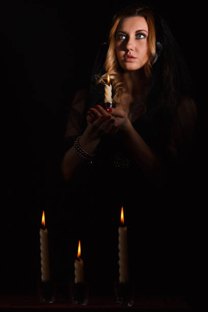 istock Scared young woman with a candle 1155812214