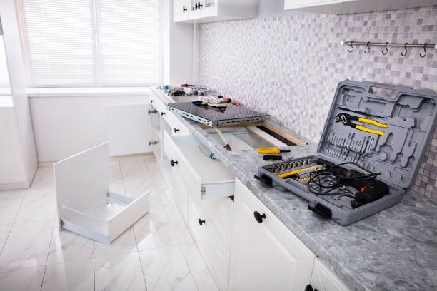 Two contractors are installing kitchen counters