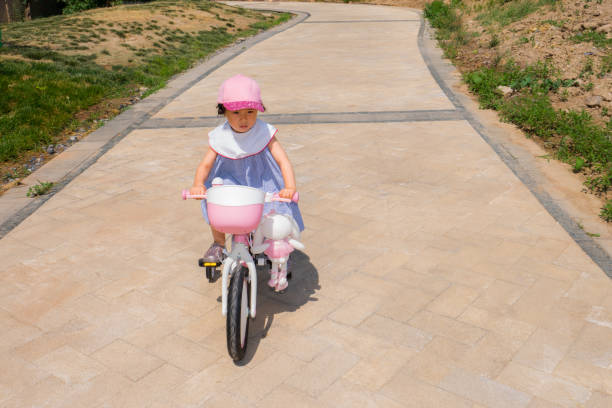 istock a young girl practice riding bicycle 1155814170