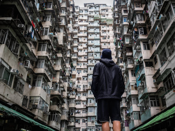 Traveler Exploring the Urban Landscape of Hong Kong, China, One of the Most Densely Populated Cities in the World Traveler exploring the urban landscape of Hong Kong, China, one of the most densely populated cities in the world. kowloon stock pictures, royalty-free photos & images