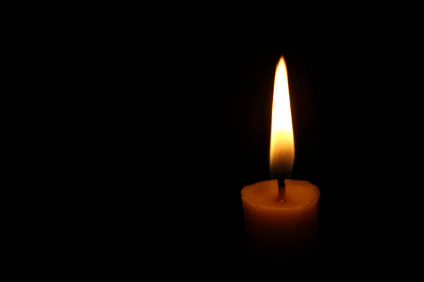 istock One candle flame at night closeup 1155816658