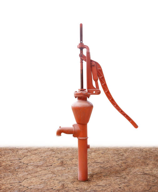 istock Old manual water pump (Lever Pumps) on dry ground. 1155817808