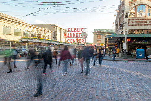 Seattle, Washington, USA / March 2019: Long exposure photo of people crossing the street in front of Public Market Center on 1st Avenue and Pike Place in downtown Seattle.