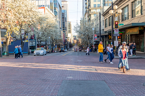 Seattle, Washington, USA / March 2019: People crossing the street in downtown Seattle going to the public market.