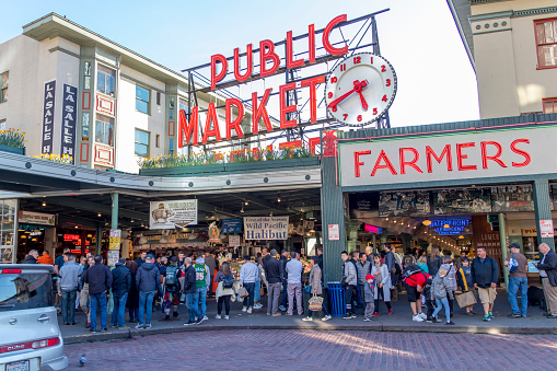 Seattle, Washington, USA / March 2019: A multitude of people at the entrance of the Public Market on Pike Place in Seattle.