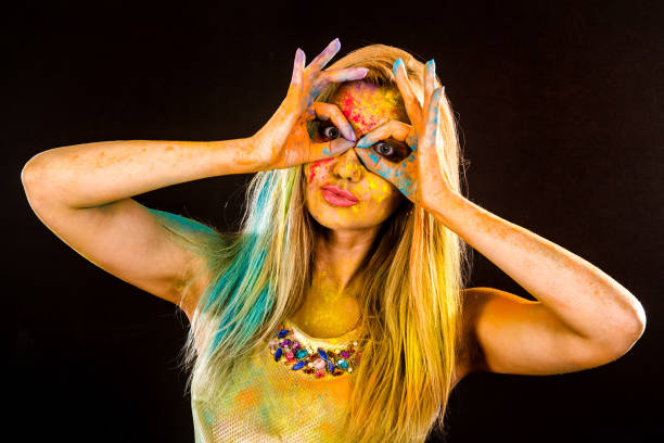 istock Beautiful young woman with colored powder 1155819605