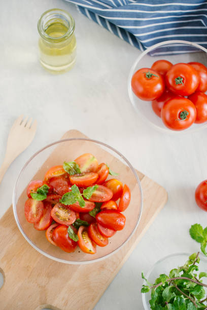 istock Fresh delicious salad with tomatoes. Doing fresh green salad 1155820610