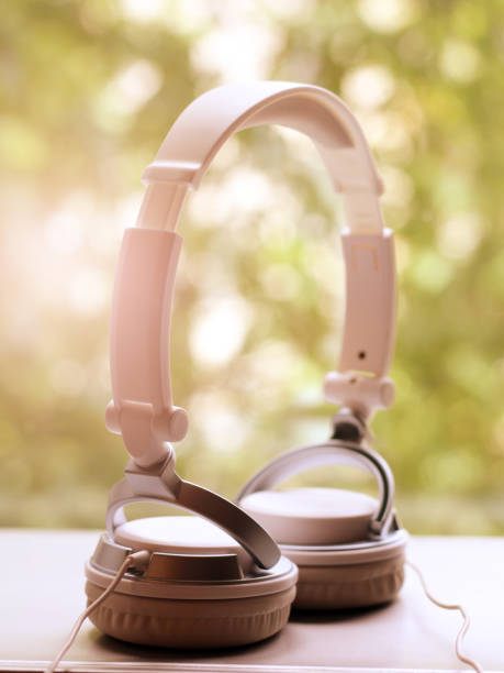 istock White elegance headfones on nature background 1155821866