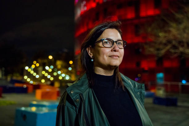 istock Middle aged woman walking in Barcelona at night 1155826141