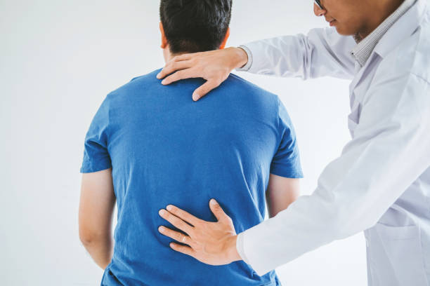 istock Physical Doctor consulting with patient about Back problems Physical therapy concept 1155828210