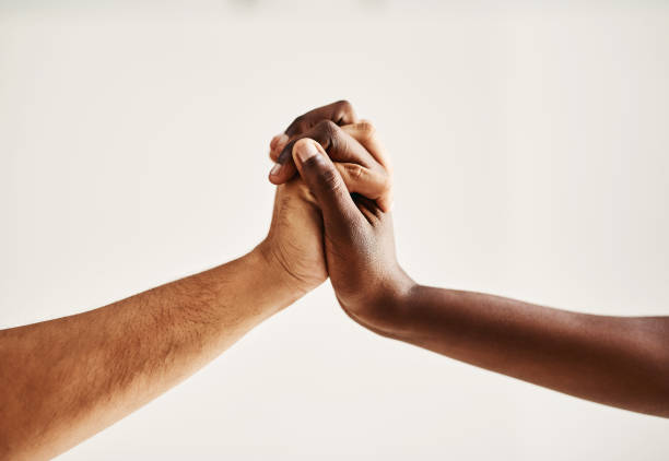 hold on to hope - reaching human hand handshake support imagens e fotografias de stock