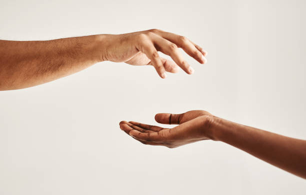 Take my hand and let me help you Closeup shot of two unrecognisable people reaching for each other with their hands reaching stock pictures, royalty-free photos & images