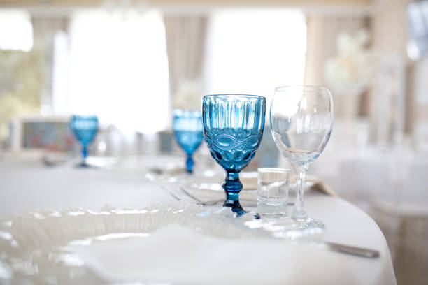 istock Blue and transparent glasses and plates on the table. 1155831912