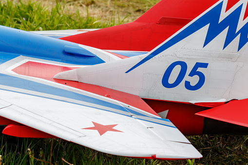 Balashikha, Moscow region, Russia - May 25, 2019: Tail and wings of big scale RC model with jet engine of aircraft MIG-29 of RusJet team closeup at aviation festival Sky Theory and Practice 2019