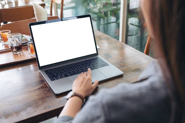 istock a woman using and touching laptop touchpad with blank white desktop screen 1155836344
