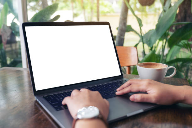 istock a woman using and typing on laptop with blank white desktop screen 1155836355