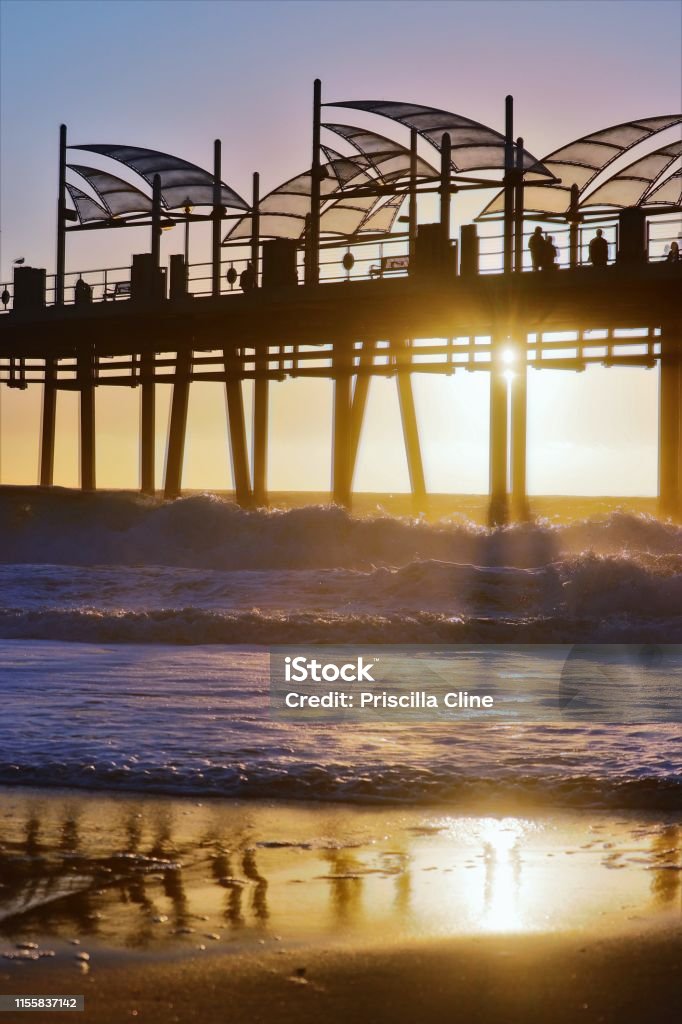 Golden redondo pier sunset Redondo pier reflection on sand Redondo Beach - California Stock Photo