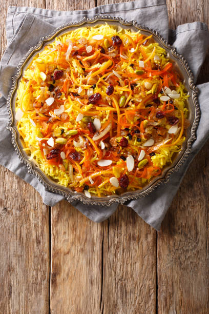 istock Javaher Polow (jeweled rice) is a traditional Persian rice dish closeup on a plate. Vertical top view 1155837246