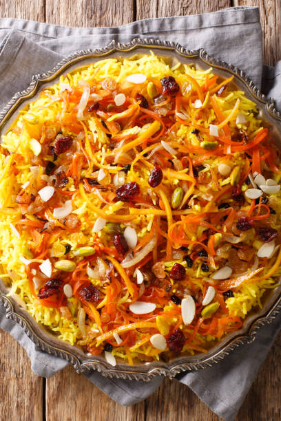 istock Persian delicious pilaf Javaher Polow (jeweled rice) closeup on a plate on the table. Vertical top view 1155837647