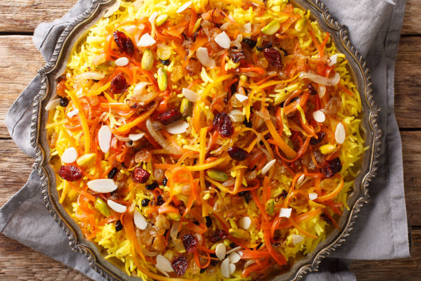 istock Persian delicious pilaf Javaher Polow (jeweled rice) closeup on a plate on the table. horizontal top view 1155837657