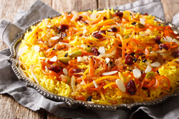 istock Persian delicious pilaf Javaher Polow (jeweled rice) closeup on a plate on the table. horizontal 1155838170