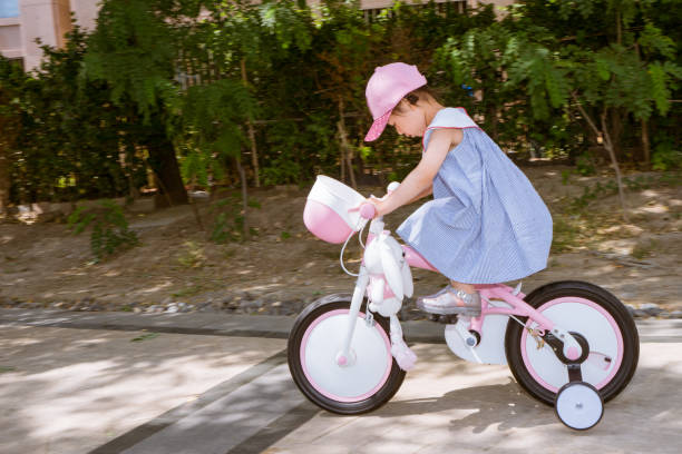 istock a young girl practice riding bicycle 1155838189