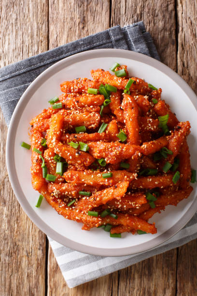 istock Crispy Honey Chilli Potatoes Delicious spicy snack on a plate close-up. Vertical top view 1155838431