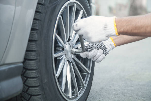 istock Changing car tire. Car service. Tire installation concept 1155840192