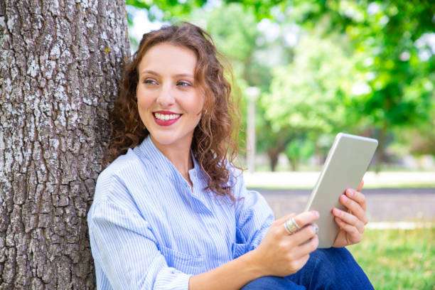 istock Happy beautiful woman using mobile internet on tablet 1155840489