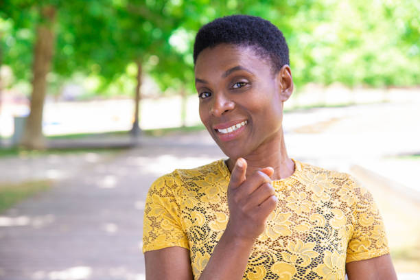 istock Smiling confident black woman pointing with finger at camera 1155840533