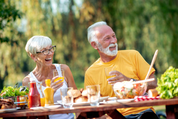 istock Senior couple having lunch in nature 1155842824