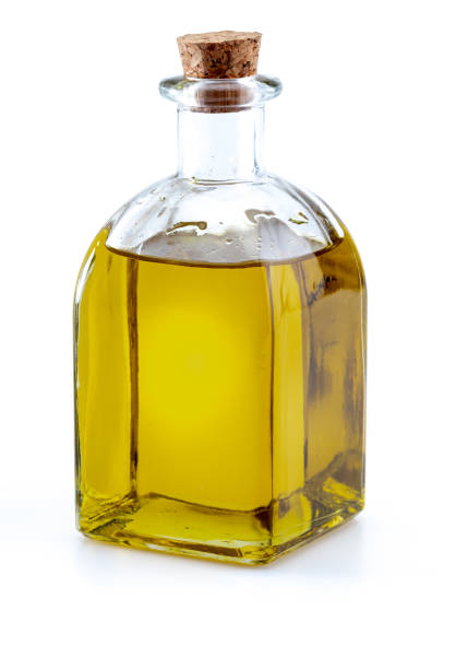 istock Extra virgin olive oil in glass bottle. Foreground. Isolated on white background. 1155845570