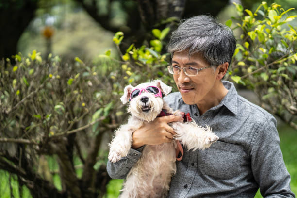 istock Mid adult asian man embracing his dog 1155846677