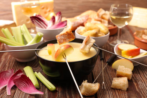 istock cheese fondue with fruit and vegetable 1155847790