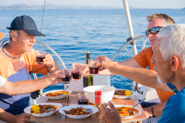 istock Cheers - for men having wine with Chili con carne on sailing boat 1155847851