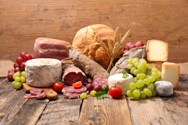 istock different sort of cheese, sausage with bread and grapes 1155848422