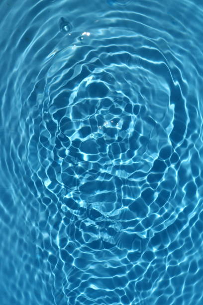istock Blue and bright water surface with sun refection in swimming pool for background 1155848743