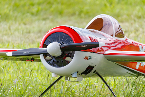 Balashikha, Moscow region, Russia - May 25, 2019: Big scale RC model of russian aerobatic aircraft YAK-55 with gasoline engine closeup on a green lawn. Aviation festival Sky Theory and Practice 2019