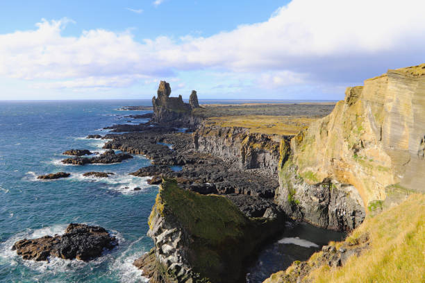 istock Rock and lava formations along the coastline and the Londrangar basalt cliffs on the southern coast of Snaefellsnes peninsula in West Iceland. 1155849638