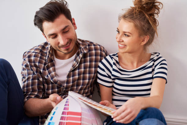 istock Young couple choosing the perfect color 1155851209