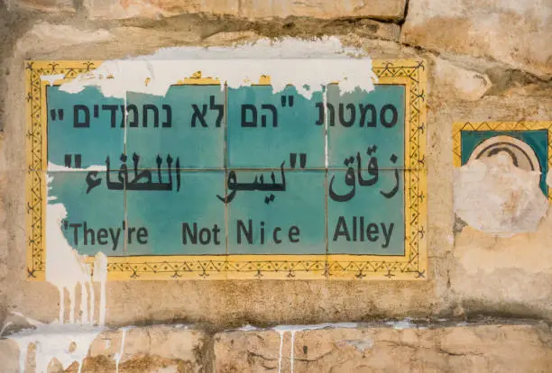 Photo of Unique street name sign on a wall in Jerusalem, social issue, social protest
