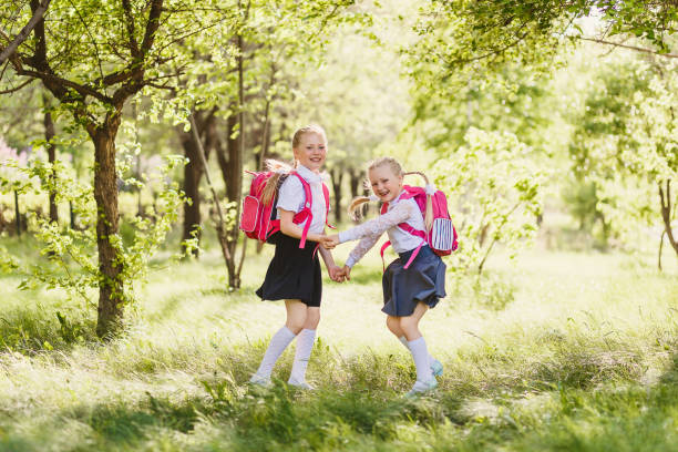 istock two happy school girls of primary classes 1155851471