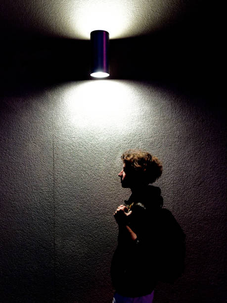 A profile portrait of the woman under the streetlight