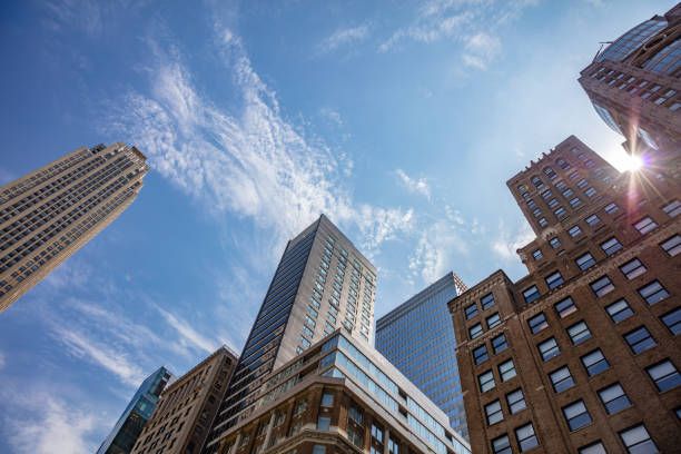 istock New York, Manhattan. High buildings view from below against blue sky background 1155854118